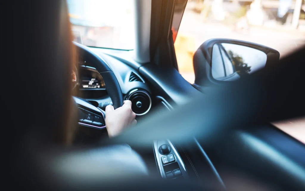 a-woman-holding-steering-wheel-with-seat-belt-fast-2024-12-01-08-07-59-utc