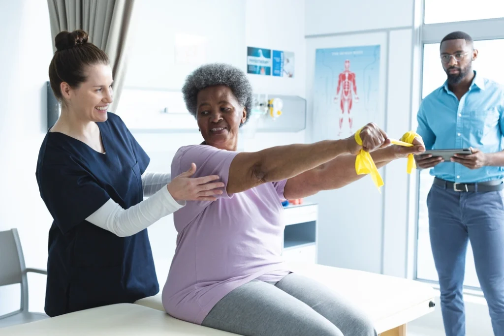 diverse-senior-female-patient-exercising-with-band-2023-11-27-05-10-24-utc