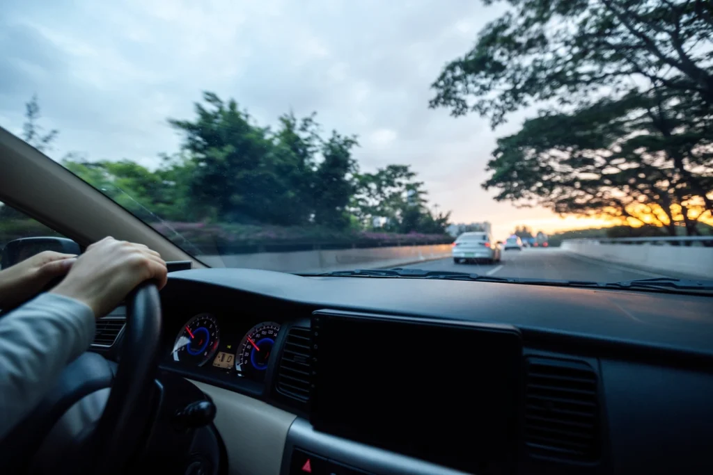 people-driving-car-on-sunrise-city-road-2024-12-06-23-54-36-utc