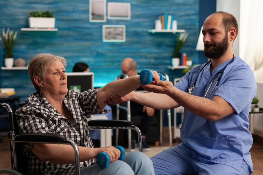 physical-therapist-helping-elderly-woman-to-exerci-2025-02-19-11-06-03-utc