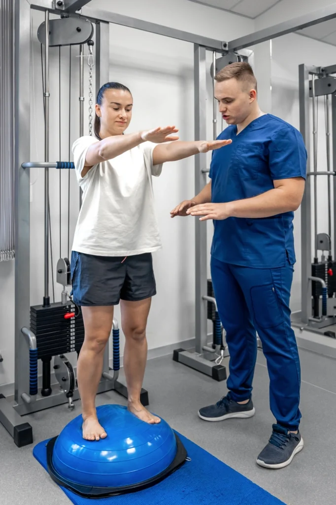 balance-exercise-with-bosu-ball-woman-and-doctor-2023-11-27-04-51-47-utc(1)